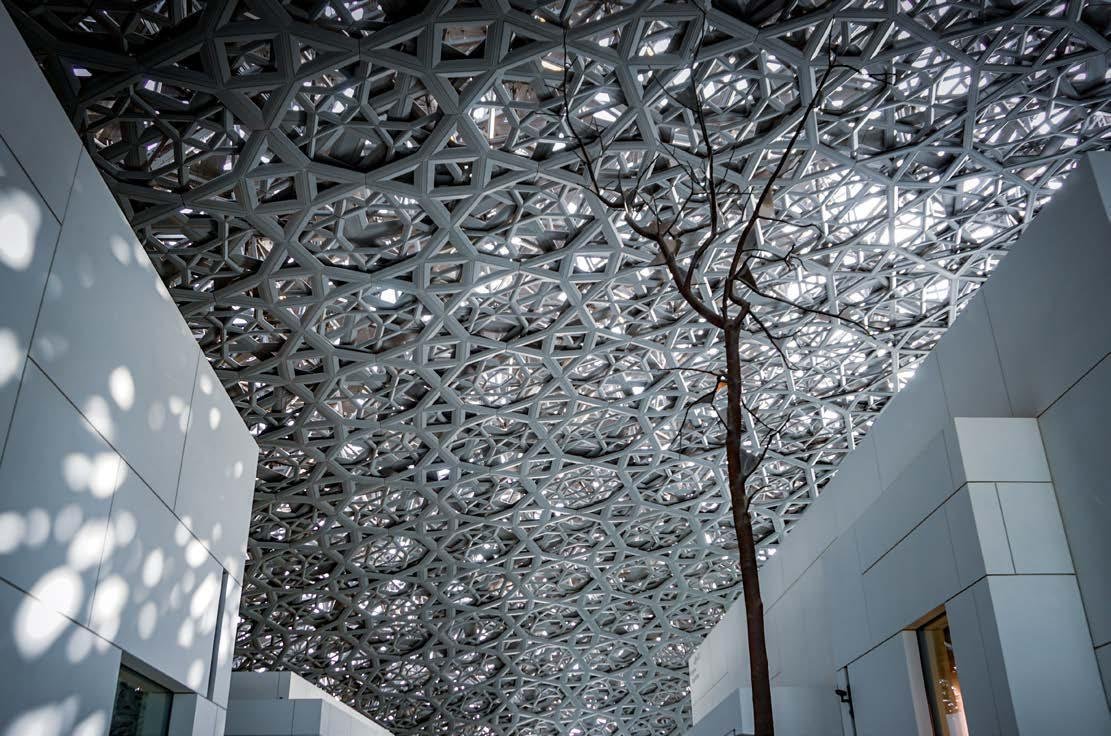 Iconic Louvre Abu Dhabi museum visible from Manchester City Ohana Residences by Ohana Yas Island, highlighting 22-minute accessibility for residents.